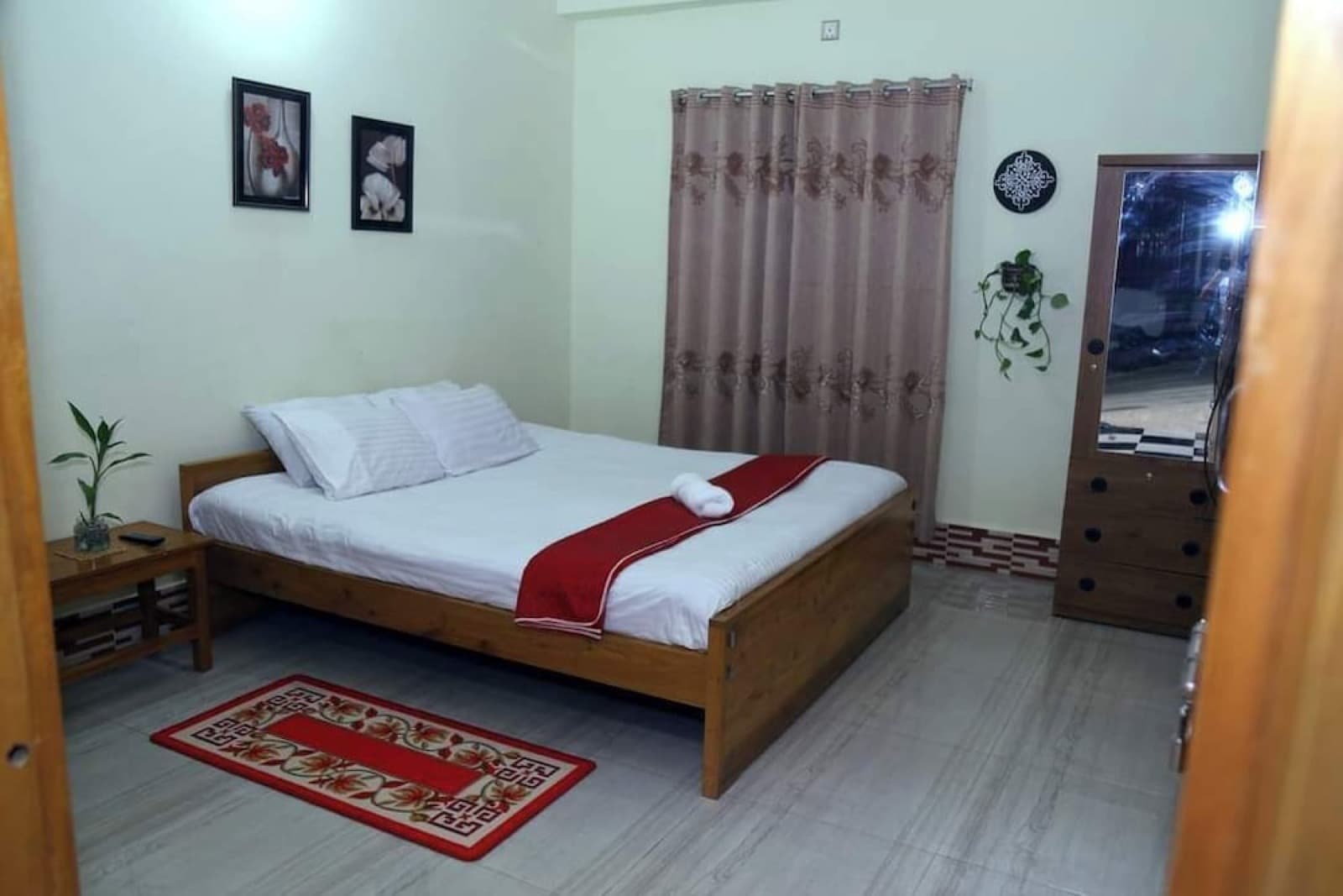 A double bedroom with wooden furniture at Brishti Bilash Guesthouse