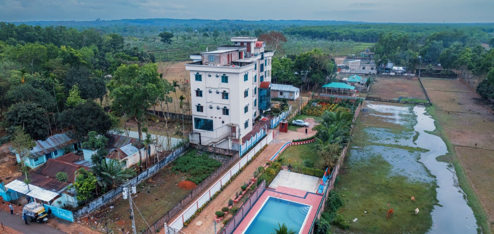 Aerial view of Grand Selim Resort & Tour's multi-storey building and pool surrounded by countryside