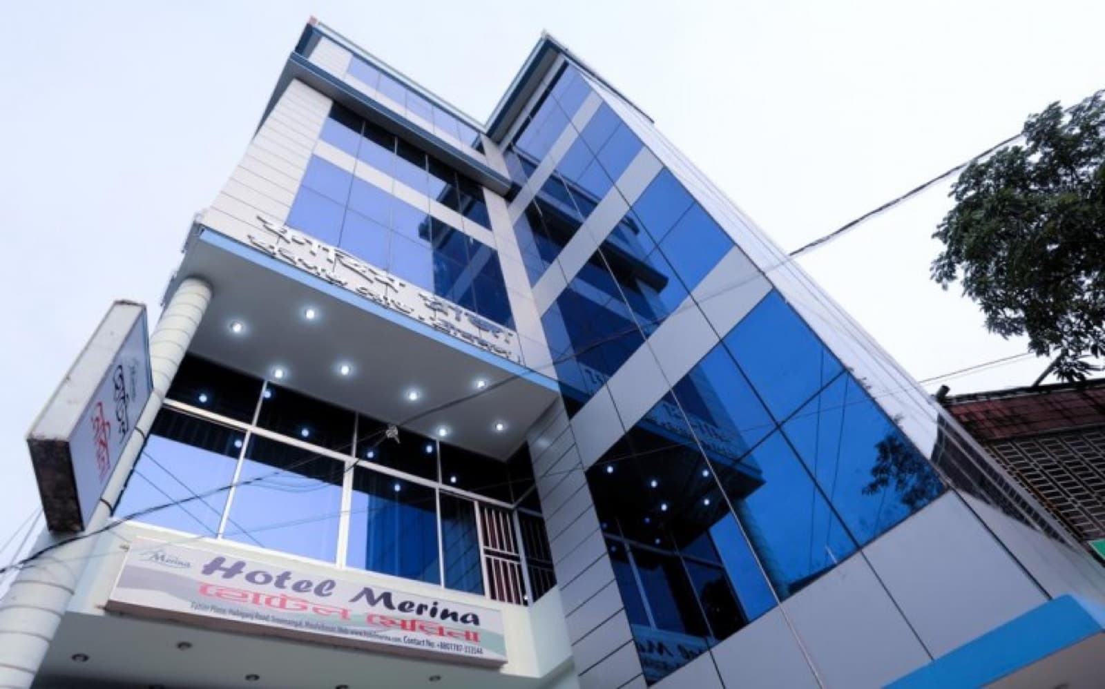 The glass-fronted exterior of Hotel Merina in Fahim Plaza, Sreemangal