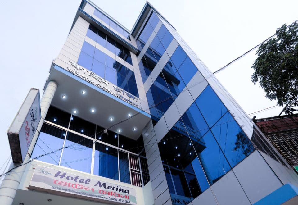 Hotel Merina's glass-fronted building in Fahim Plaza, Habiganj Road, with its illuminated signboard