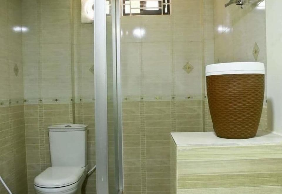 An en-suite bathroom at Resort World with a shower stall and toilet