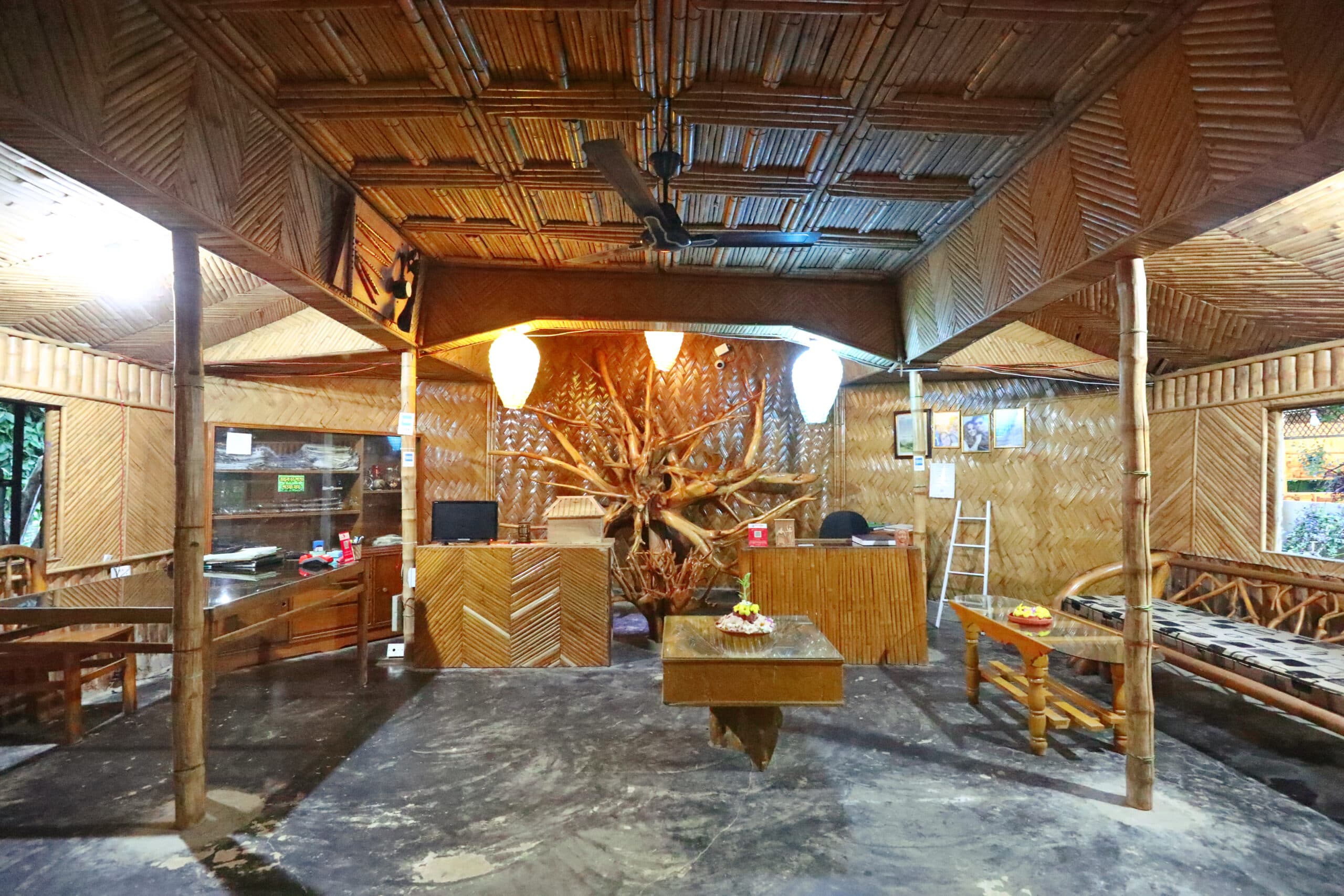 Swiss Valley Resort's bamboo-woven reception lounge with a large gnarled tree-root sculpture as the centerpiece