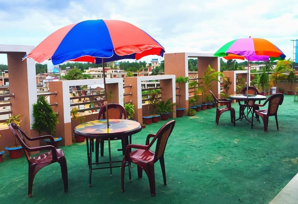 Hotel Skypark's rooftop terrace with colourful patio umbrellas and chairs overlooking the town